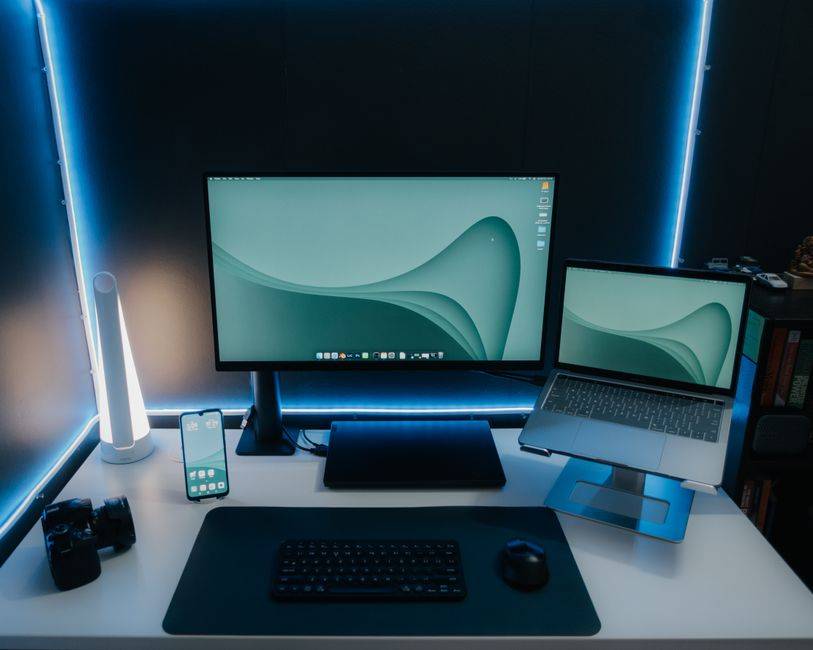 Gaming setup with monitor, laptop, and smartphone illustrating cybersecurity and tech guides.