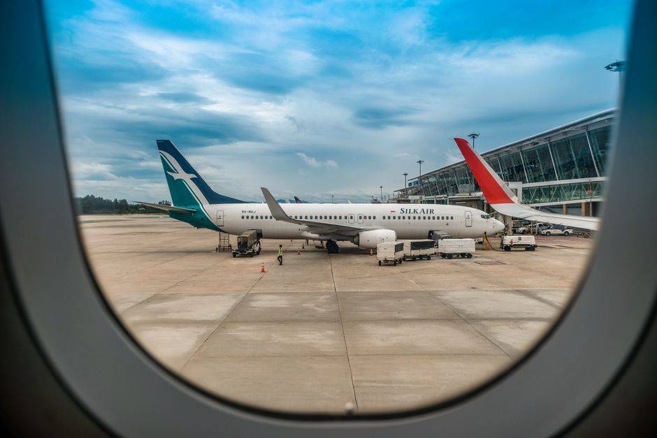 Airplane through window illustrating bypassing geo-restrictions and global VPN network.