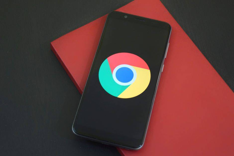 Smartphone displaying Chrome browser icon, illustrating VPN setup for PlayStation 5.