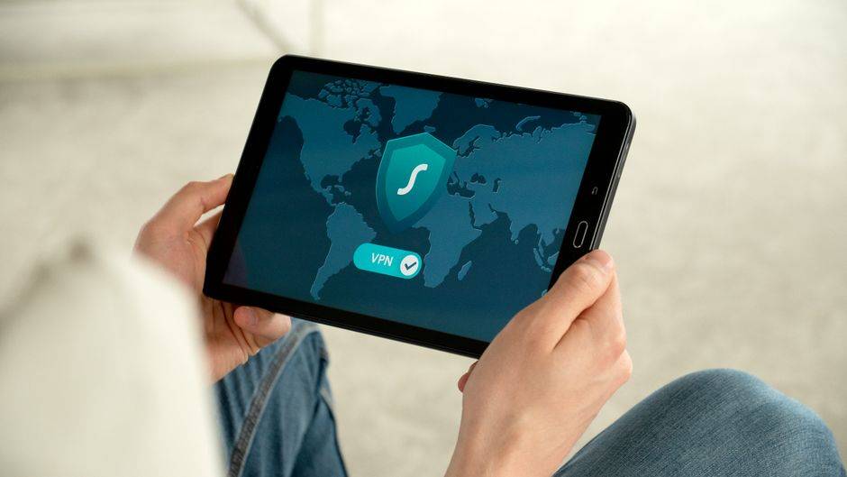 Tablet displaying world map with VPN shield icon, illustrating secure online gaming with NordVPN.